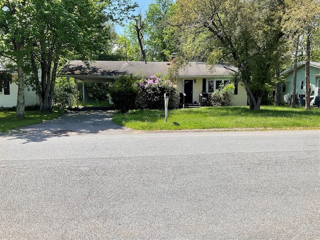 single story home featuring a front yard and a carport