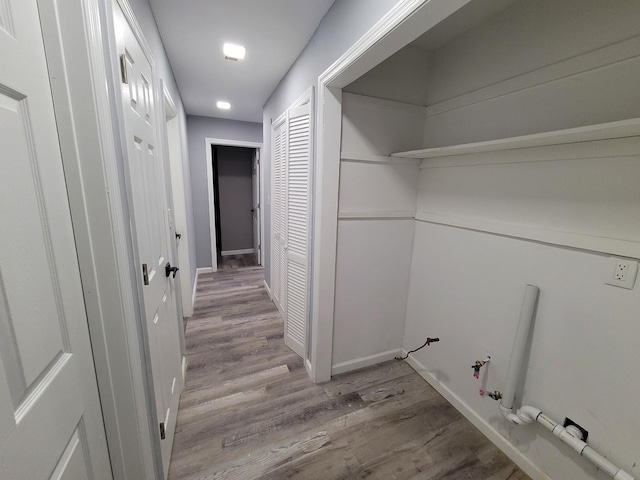 laundry room featuring light wood-type flooring and hookup for a gas dryer