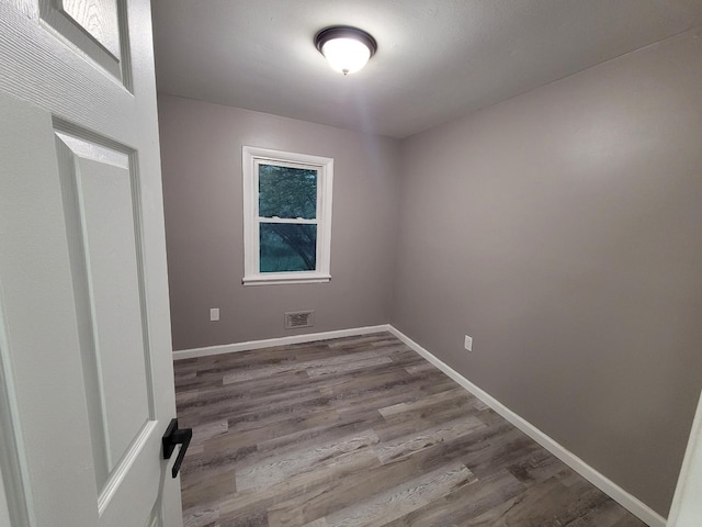 empty room with hardwood / wood-style flooring