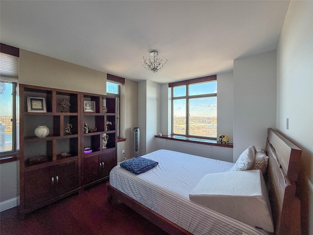 bedroom with dark colored carpet