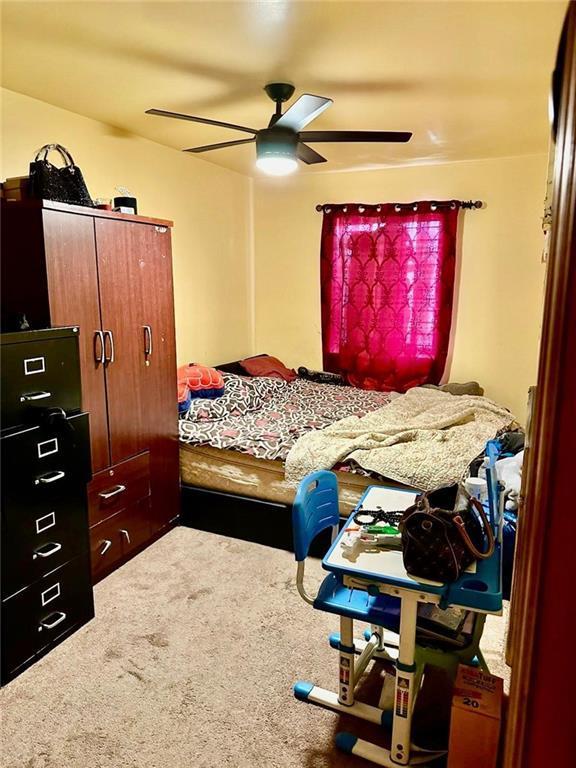 carpeted bedroom with ceiling fan