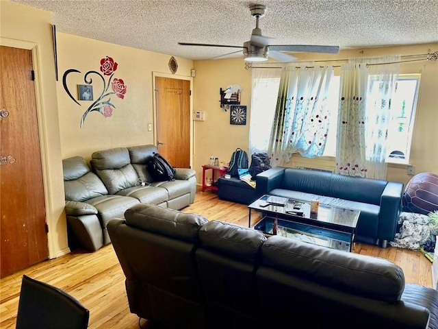 living room featuring ceiling fan, hardwood / wood-style floors, and plenty of natural light