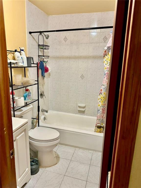 full bathroom with vanity, toilet, and shower / bath combination with curtain