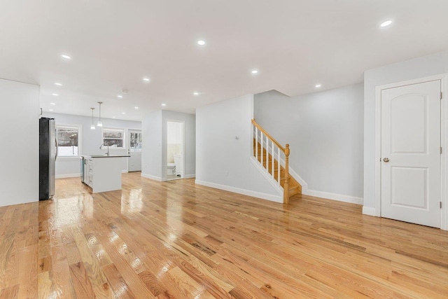 unfurnished living room featuring light wood-type flooring