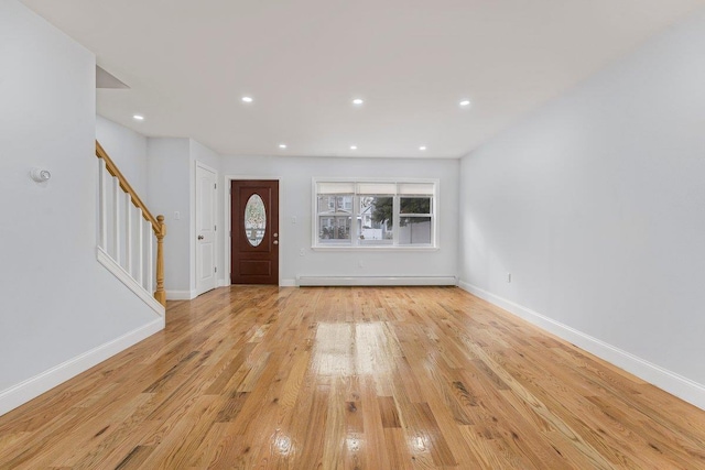 entrance foyer featuring light wood-type flooring and a baseboard heating unit