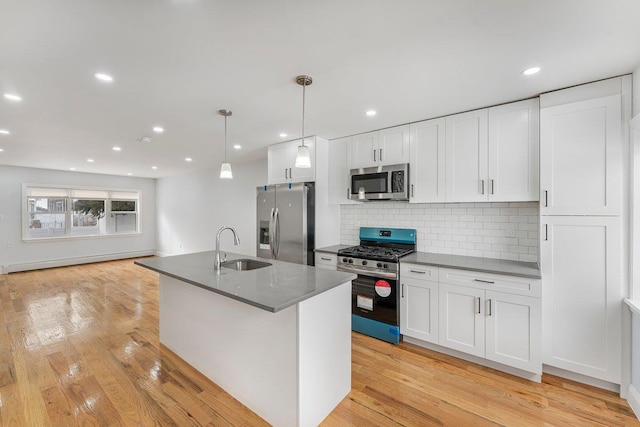 kitchen with sink, baseboard heating, white cabinetry, and appliances with stainless steel finishes