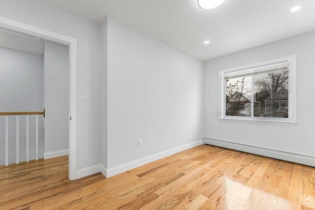 spare room with light hardwood / wood-style flooring and baseboard heating