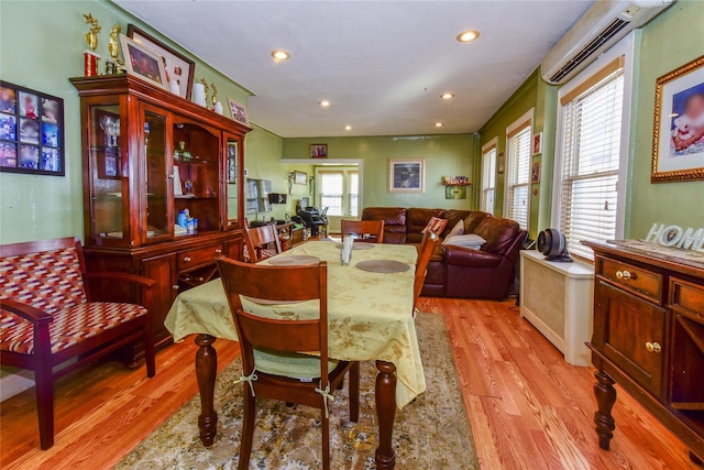 dining room with light hardwood / wood-style flooring and plenty of natural light