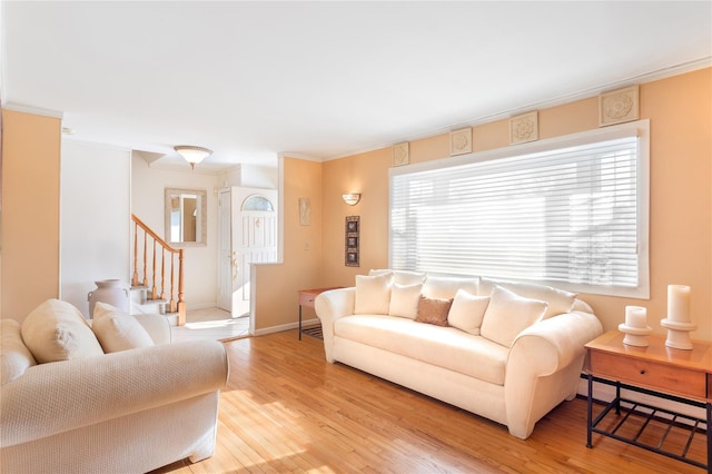 living room with a baseboard heating unit and light wood-type flooring