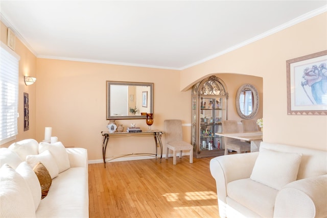 living room with hardwood / wood-style floors and ornamental molding