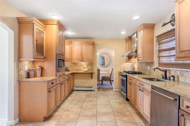 kitchen featuring sink, baseboard heating, stainless steel appliances, light brown cabinetry, and wall chimney exhaust hood