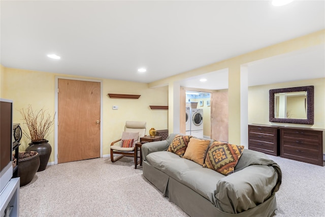 living room featuring separate washer and dryer and light carpet