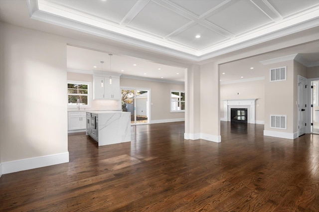 unfurnished living room with dark wood-type flooring, sink, crown molding, and coffered ceiling