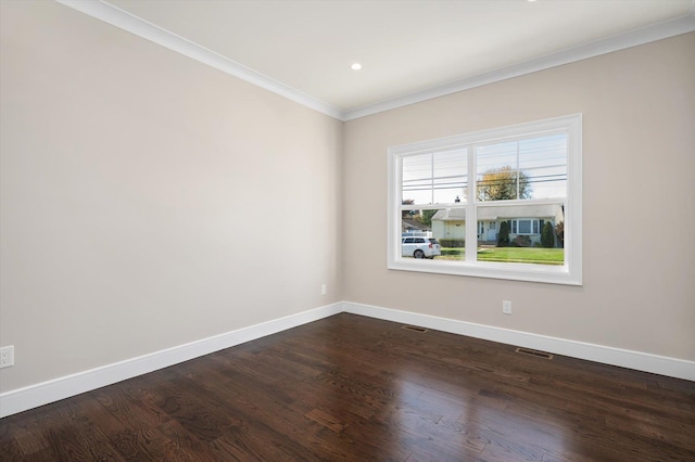 spare room with crown molding and dark wood-type flooring