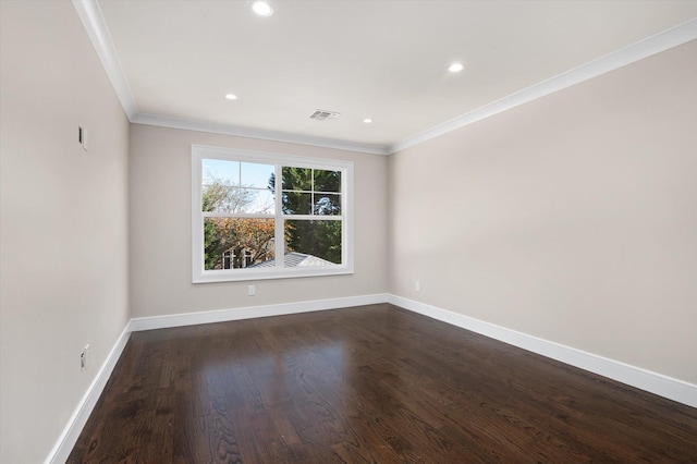 empty room with ornamental molding and dark hardwood / wood-style flooring