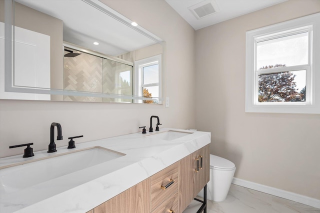 bathroom featuring toilet, an enclosed shower, and vanity