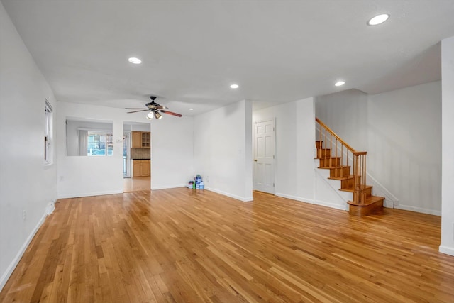 unfurnished living room with ceiling fan and light wood-type flooring