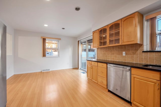 kitchen with backsplash, stainless steel dishwasher, sink, and light wood-type flooring