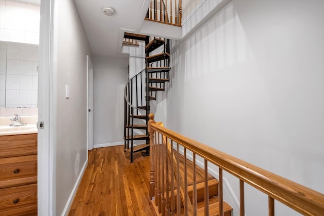 hallway featuring sink and light wood-type flooring