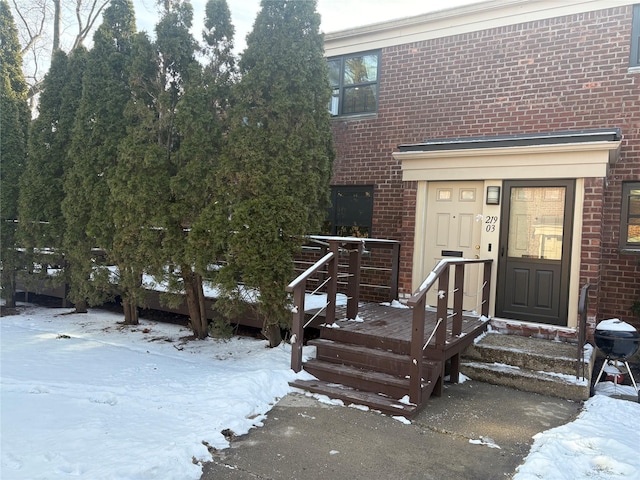 view of snow covered property entrance