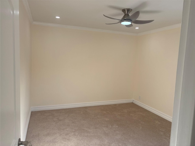 carpeted empty room featuring ornamental molding and ceiling fan