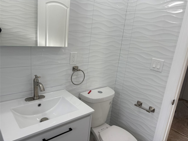 bathroom featuring vanity, tasteful backsplash, tile walls, and toilet