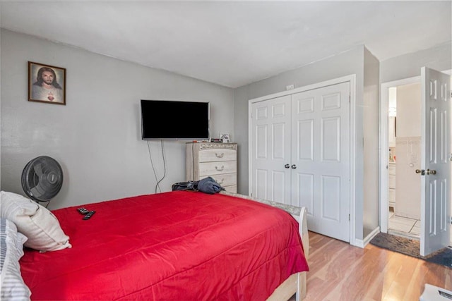 bedroom featuring a closet and light wood-type flooring