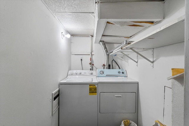 laundry room with washing machine and clothes dryer