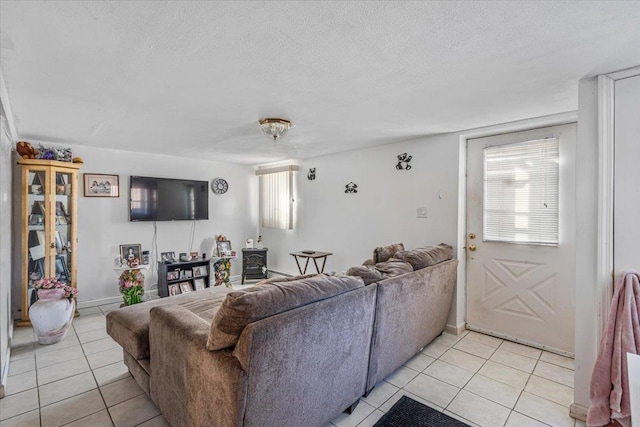 living room featuring a textured ceiling and light tile patterned flooring