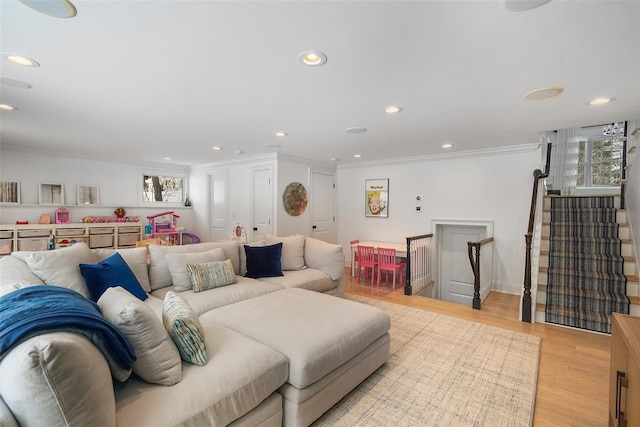 living room with crown molding and light wood-type flooring