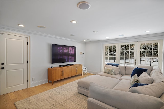 living room featuring ornamental molding and light wood-type flooring