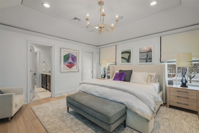 bedroom featuring connected bathroom, multiple windows, ornamental molding, light hardwood / wood-style floors, and an inviting chandelier