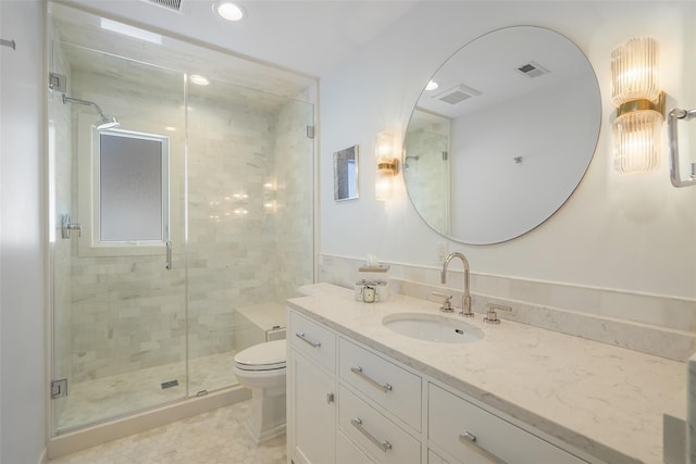 bathroom with tile patterned flooring, vanity, an enclosed shower, and toilet