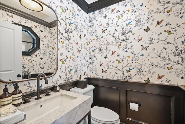 bathroom featuring vanity, ornamental molding, and toilet