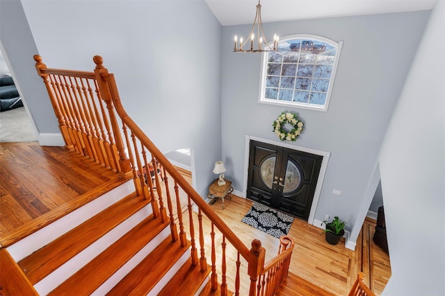 foyer entrance featuring a notable chandelier and wood-type flooring