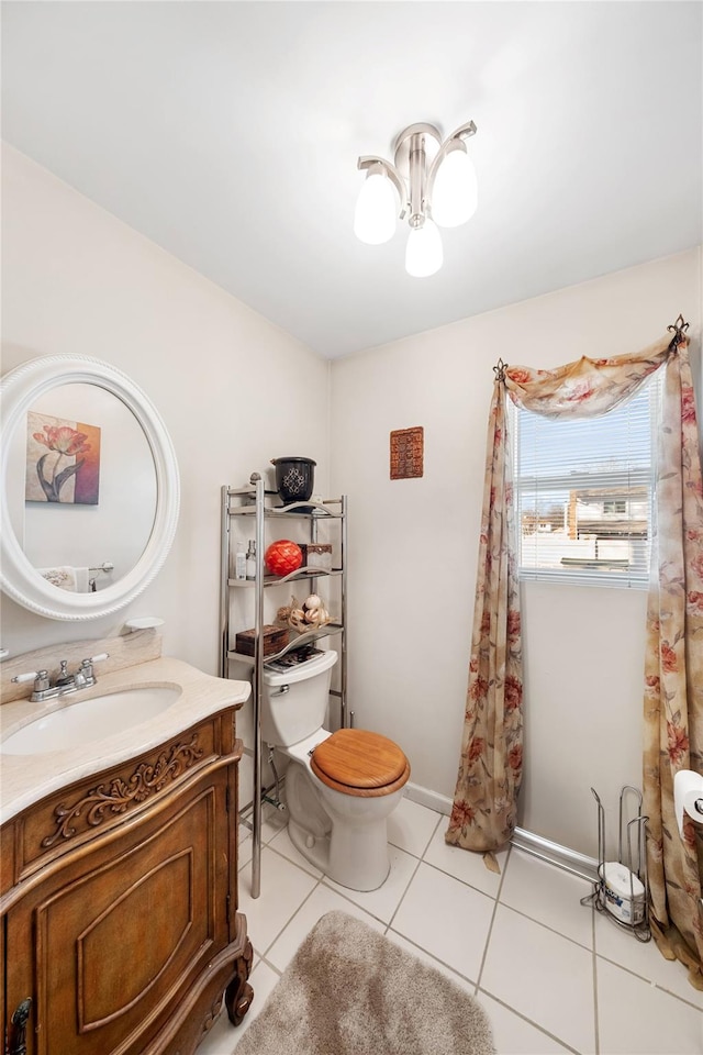 bathroom featuring vanity, a notable chandelier, tile patterned floors, and toilet