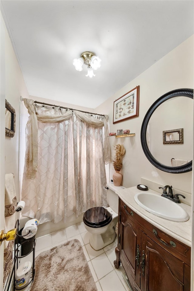 full bathroom featuring toilet, vanity, tile patterned floors, and shower / bath combo with shower curtain