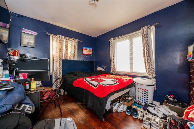 bedroom with dark wood-type flooring