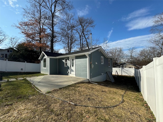 back of house featuring a patio area and a yard