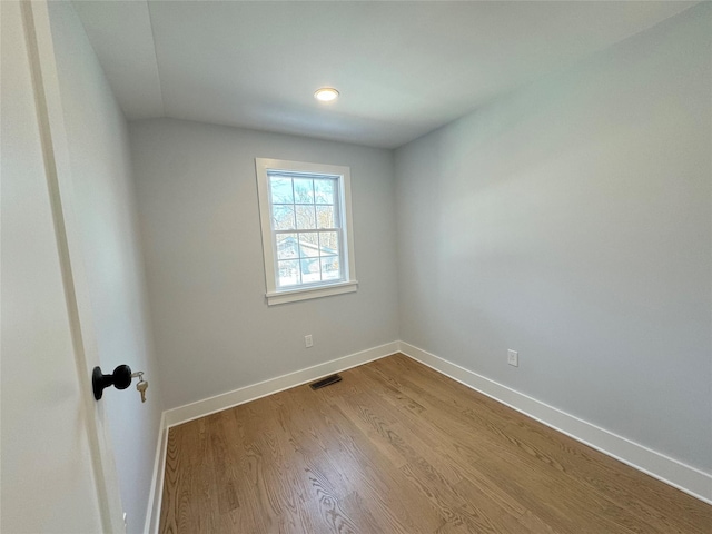 empty room featuring hardwood / wood-style flooring