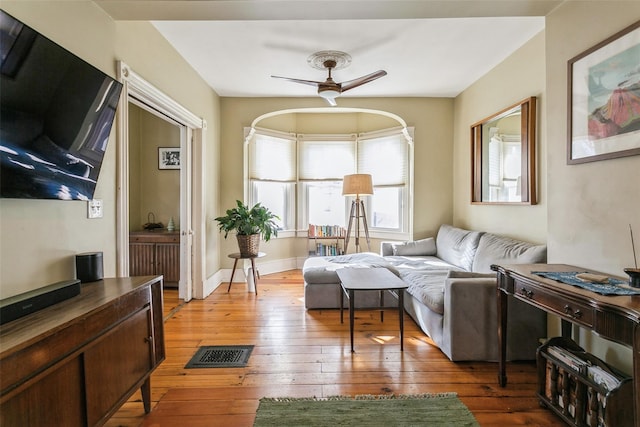 living room with hardwood / wood-style flooring and ceiling fan