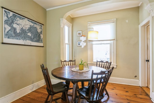 dining space featuring hardwood / wood-style flooring and ornamental molding