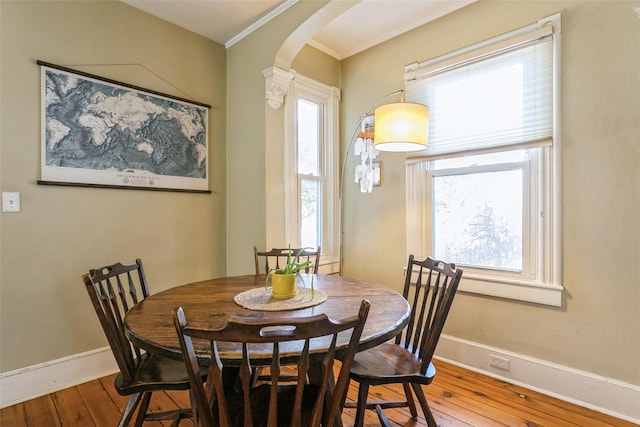 dining room with hardwood / wood-style flooring and a healthy amount of sunlight