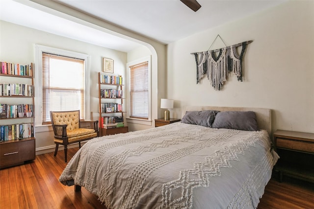 bedroom with dark hardwood / wood-style floors and ceiling fan