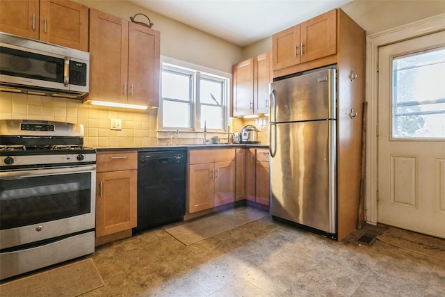 kitchen with stainless steel appliances and backsplash