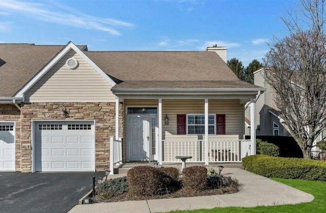 view of front of house featuring a garage and covered porch