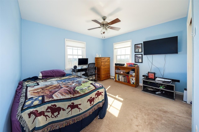 bedroom with light carpet and a ceiling fan