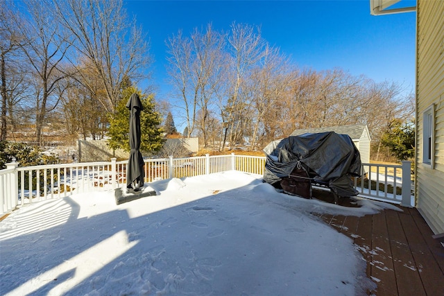 yard covered in snow featuring a deck