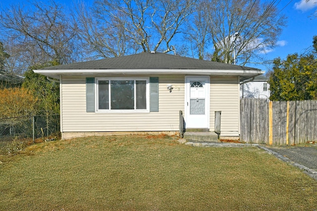 bungalow-style house featuring a front yard