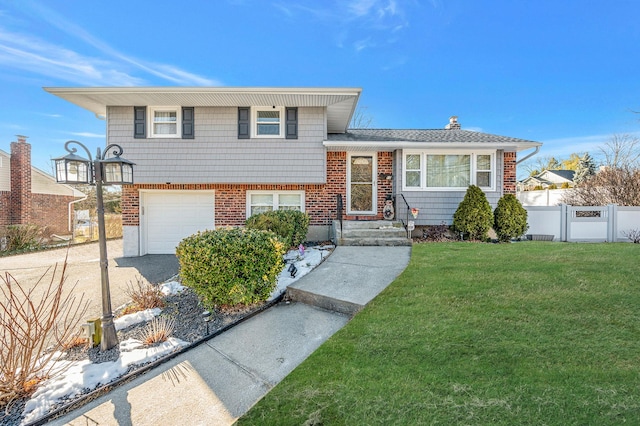 split level home with a garage and a front yard